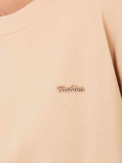 Beżowa bluza oversize z ozdobną naszywką