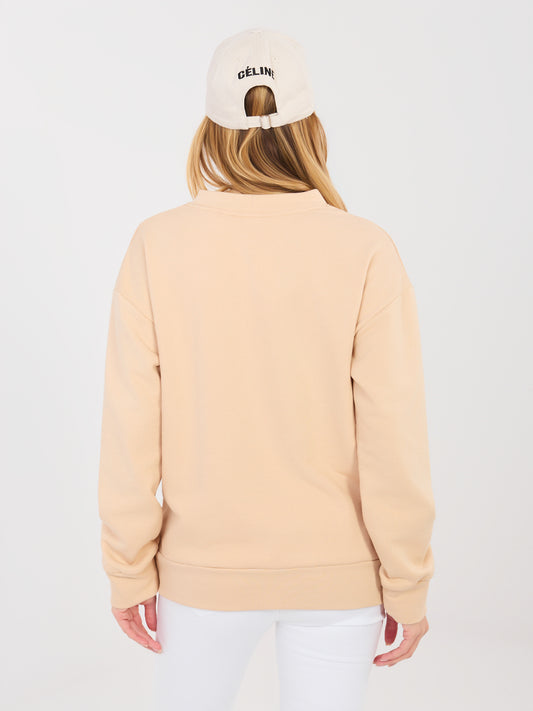 Beżowa bluza oversize z ozdobną naszywką