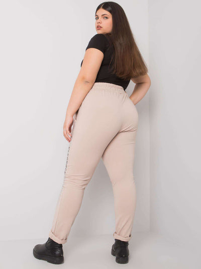 Beżowe spodnie dresowe plus size z dżetami