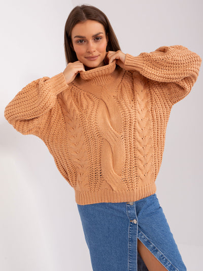 Brzoskwiniowy sweter oversize z warkoczami