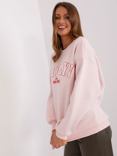 Jasnoróżowa dresowa bluza oversize z napisem