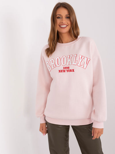 Jasnoróżowa dresowa bluza oversize z napisem